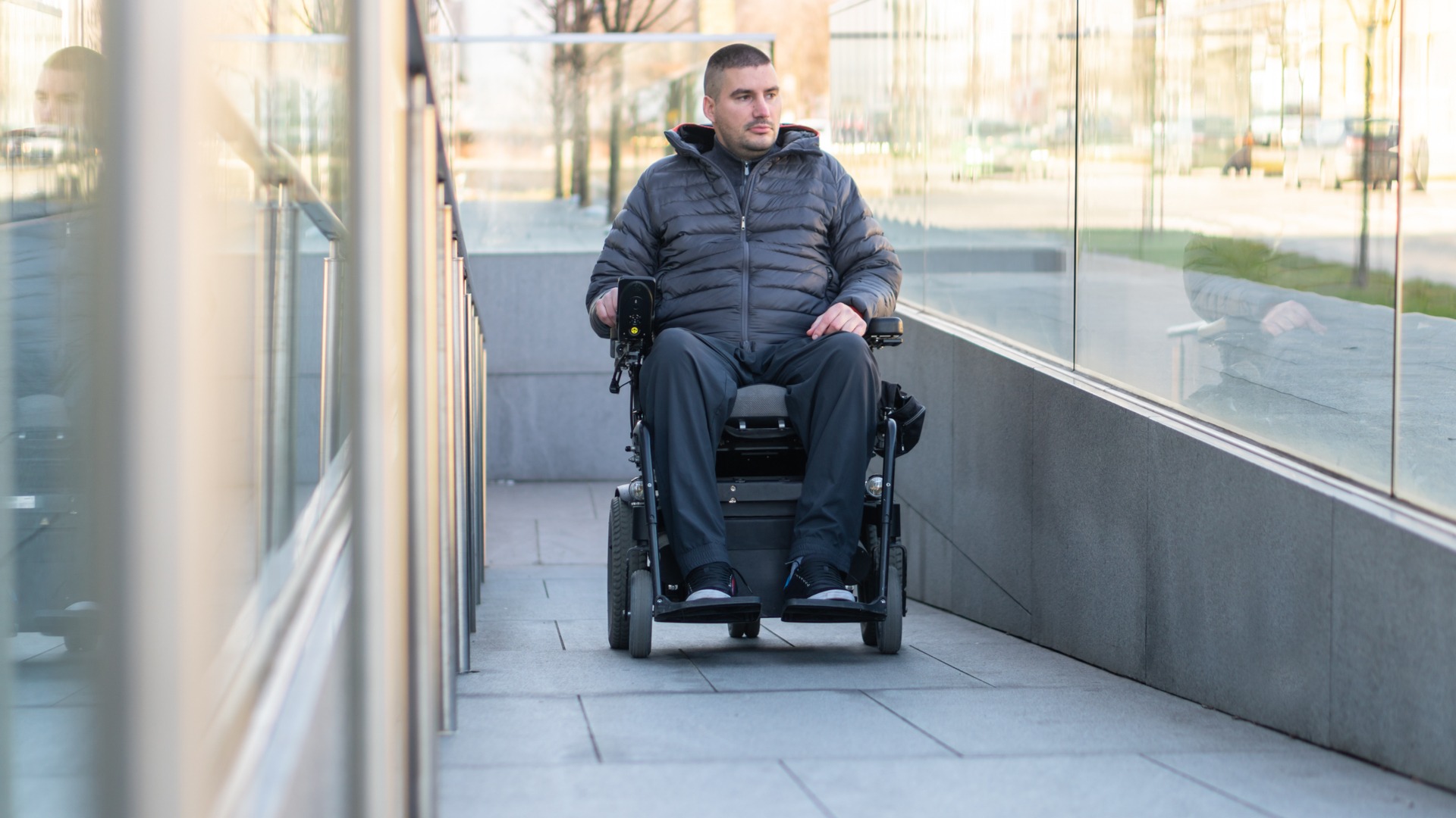 Man uses rear wheel drive powerchair in city centre